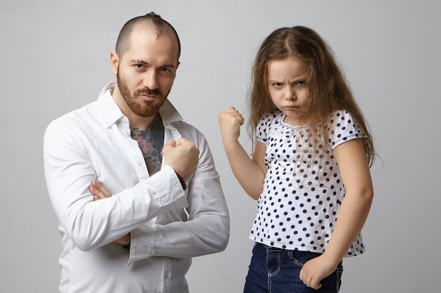 Bullying, negative emotions and reaction. Picture of emotional furious little girl posing in studio