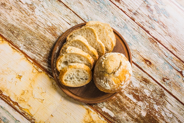 Bun and cut bread on table