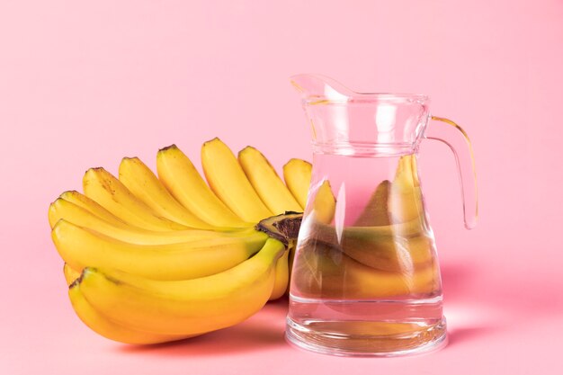 Bunch of bananas with jug of water