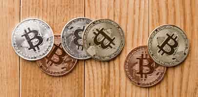 Free photo bunch of bitcoins on wooden table