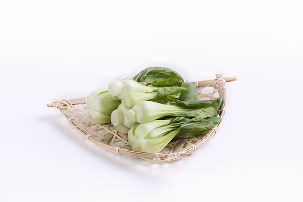 Bunch of bok choy on a straw plate