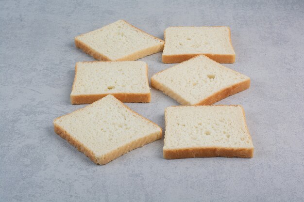 Bunch of bread slices on stone surface