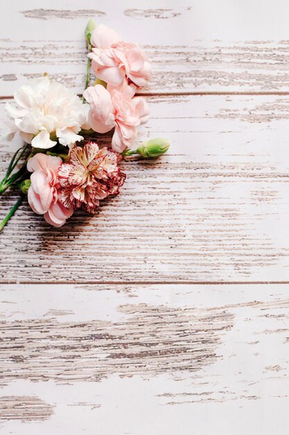 Bunch of carnation flowers with bud on old wooden table