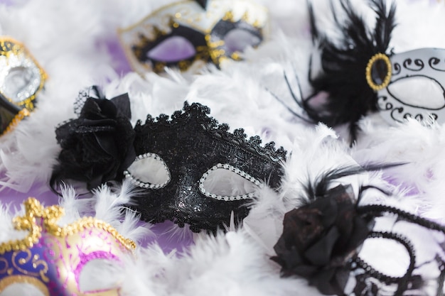 Bunch of carnival masks on feathers