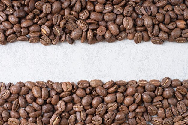 Bunch of coffee beans on stone background. High quality photo