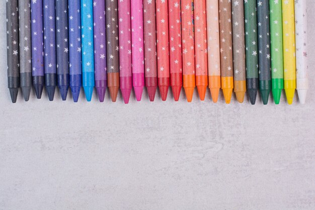 Bunch of colorful pencils on white surface