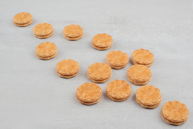 Bunch of cookies with cream on white table