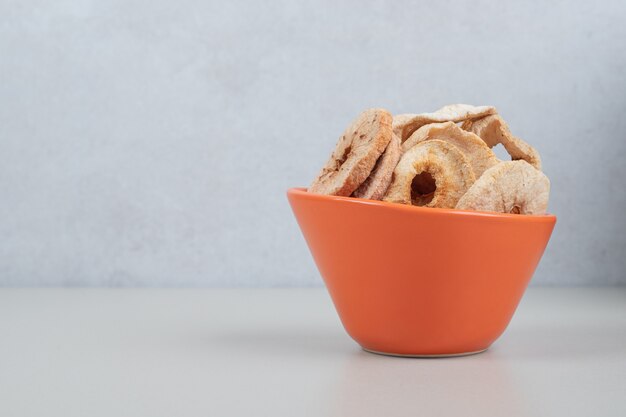 Bunch of dried fruit slices in orange bowl