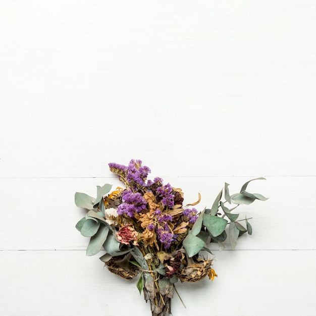 Bunch of dried herbs and flowers on white surface