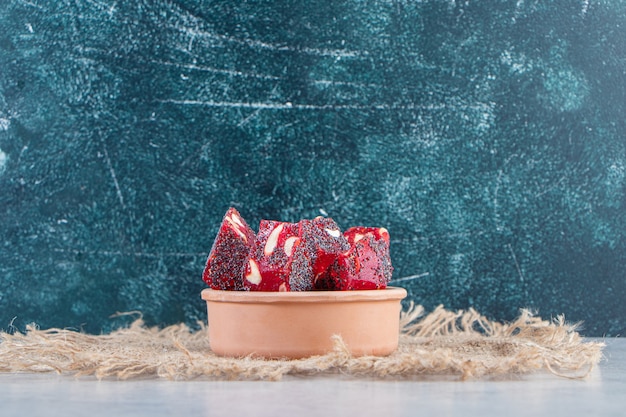 세라믹 그릇에 견과류와 말린 붉은 과일 펄프의 무리.