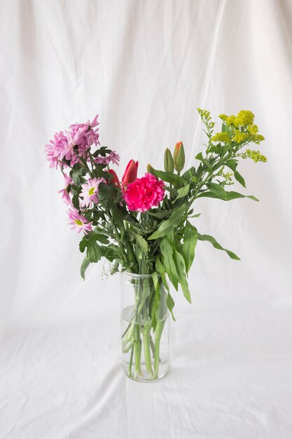 Bunch of flowers on green stems in vase