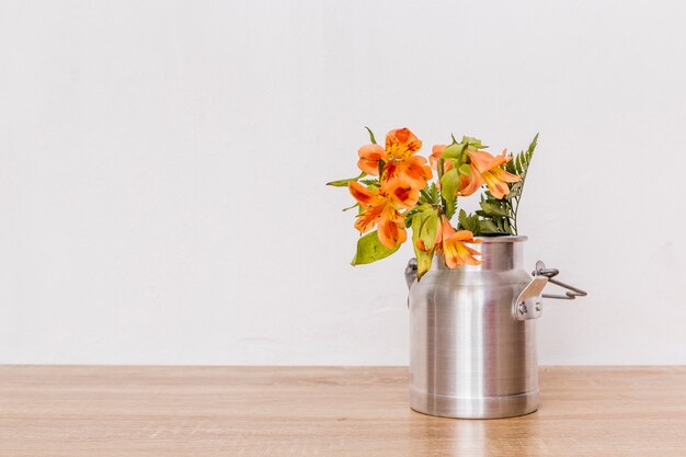 Bunch of flowers in milk can