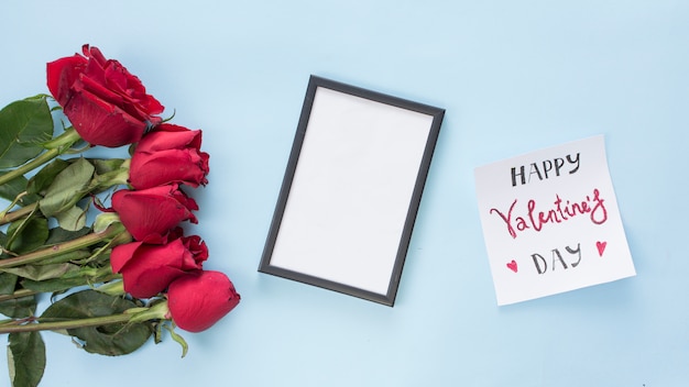 Bunch of flowers near paper with title and photo frame