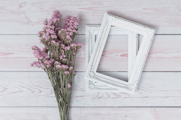 Bunch of flowers near photo frames