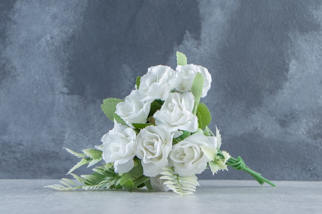 A bunch of flowers, on the white table.