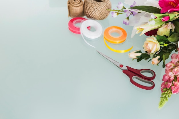 Bunch of flowers with stationeries on desk