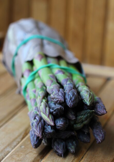 Bunch of fresh asparagus on wooden table