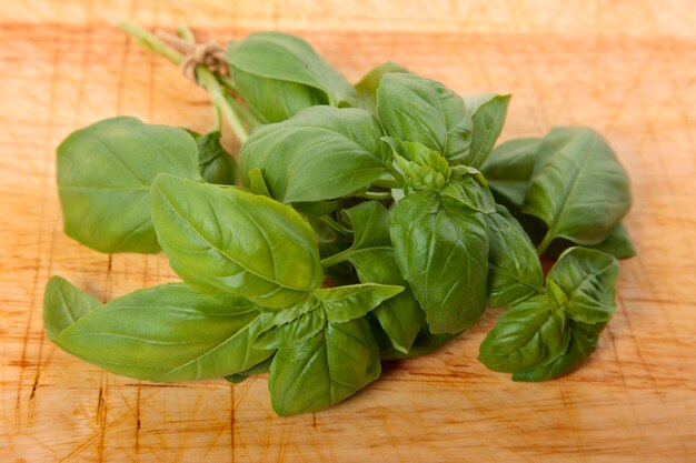 Bunch of fresh basil on wooden board