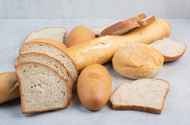 Bunch of fresh bread on marble background. High quality photo
