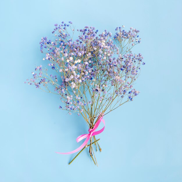 Bunch of fresh flower twigs with ribbon