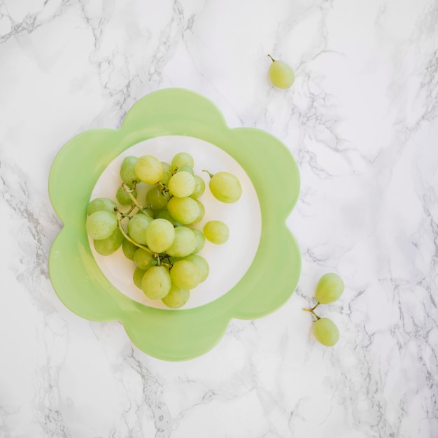 Free photo bunch of fresh green grapes on plate