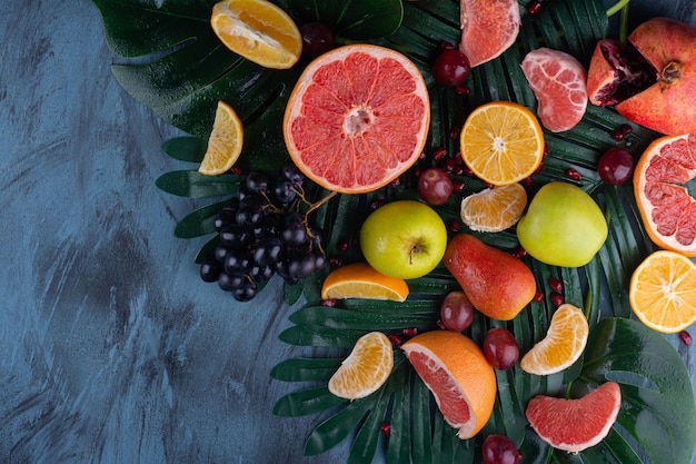 Bunch of fresh juicy fruits placed on marble table.