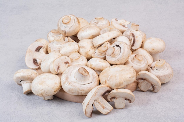 Bunch of fresh mushrooms on marble table.