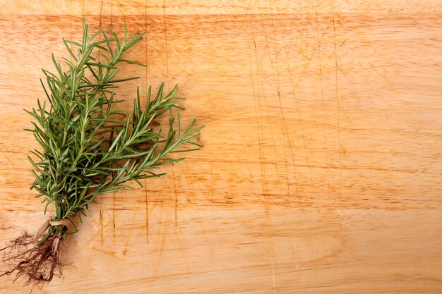 Bunch of fresh rosemary on wooden board