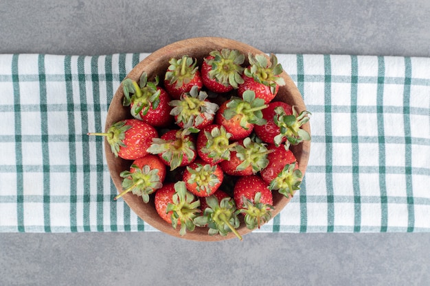 Bunch of fresh strawberries in wooden bowl. High quality photo