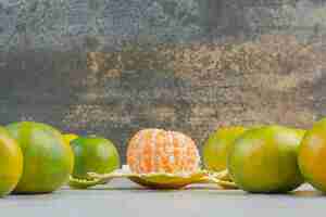 Free photo bunch of fresh tangerines on stone table. high quality photo