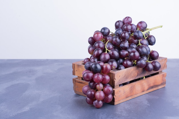 A bunch of grape in a wooden tray
