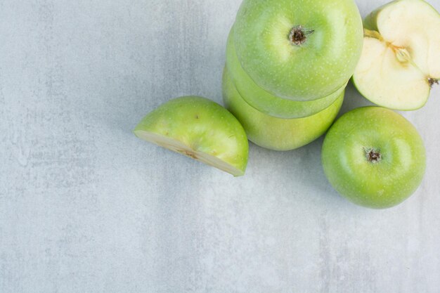 Bunch of green apples on stone background. High quality photo