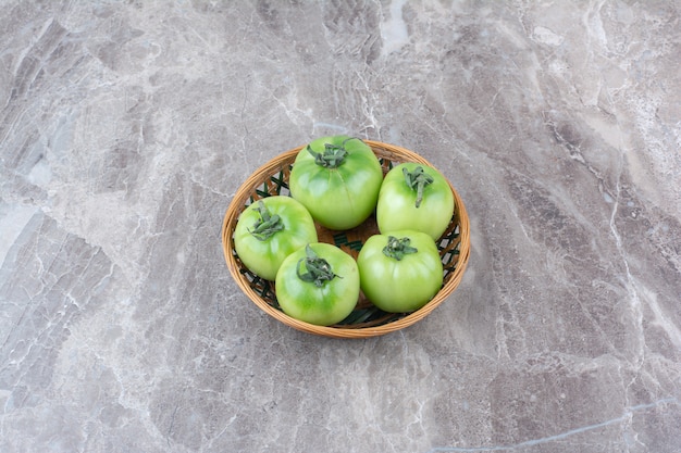 Free photo bunch of green tomatoes in ceramic bowl.