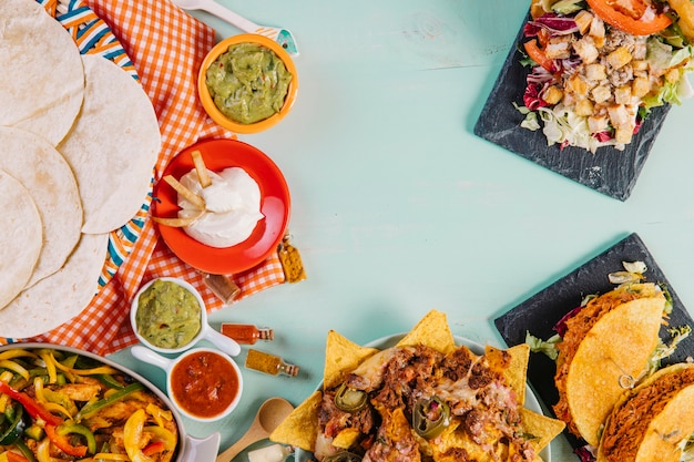 Bunch of Mexican food near tablecloth