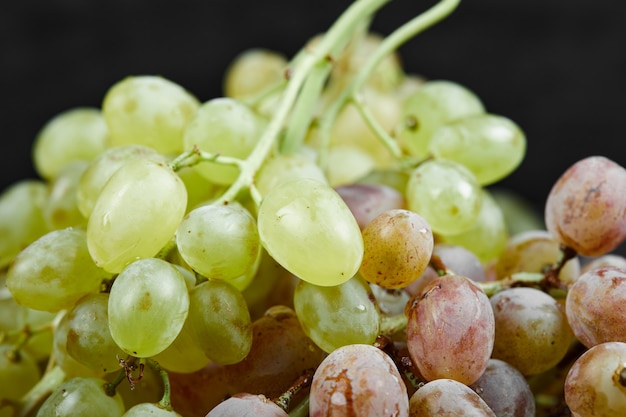 A bunch of mixed grapes on black background. High quality photo