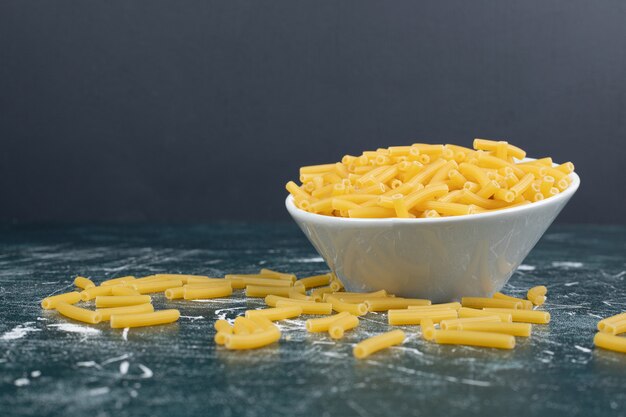 Bunch of raw pasta in white bowl. High quality photo