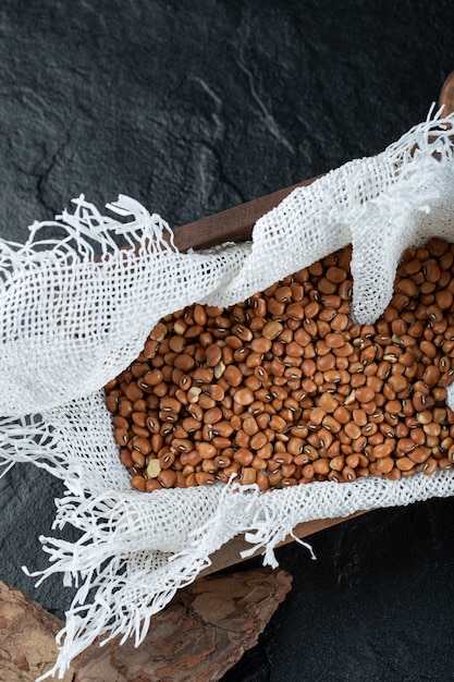 Free photo bunch of red beans in wooden box with burlap.