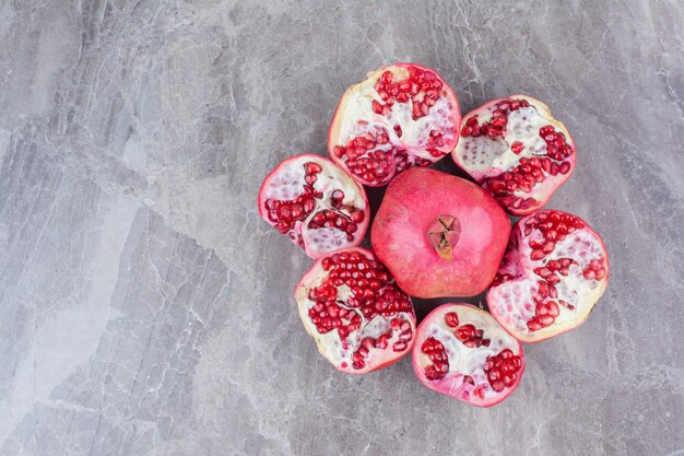 Bunch of red pomegranates on stone background. 