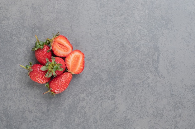 Bunch of red strawberries on marble background. High quality photo