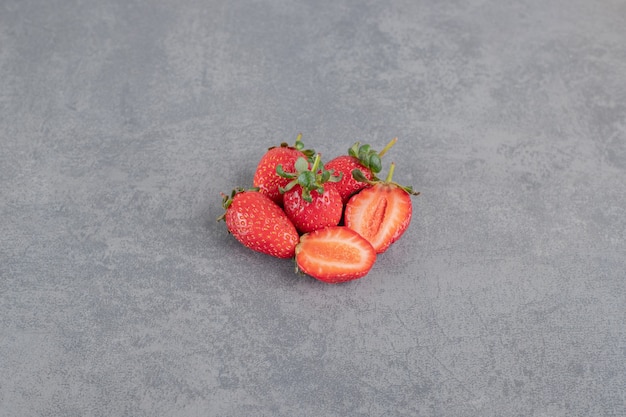 Bunch of red strawberries on marble background. High quality photo