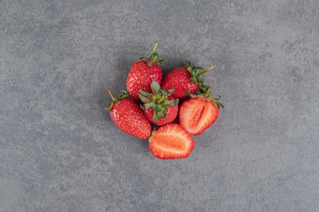 Bunch of red strawberries on marble background. High quality photo