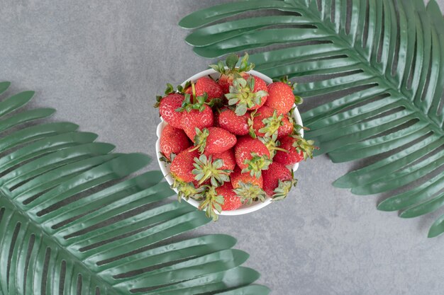 Bunch of red strawberries in white bowl. High quality photo