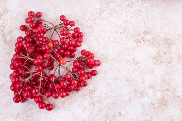 Free photo bunch of redcurrants on marble background.