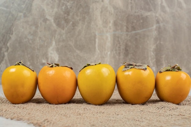 Bunch of ripe delicious persimmons on burlap