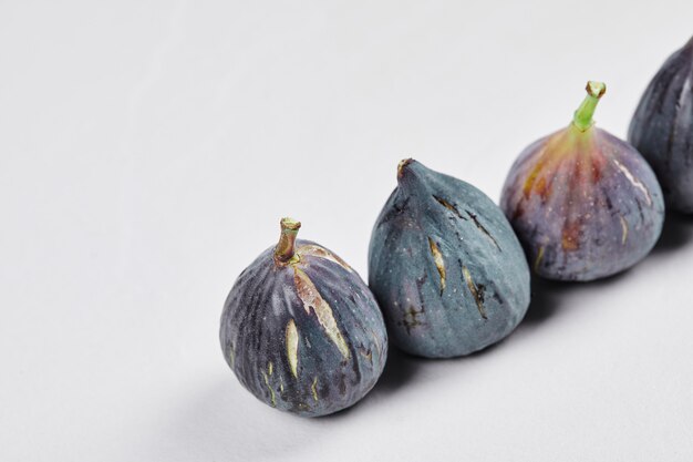 A bunch of ripe figs on white.