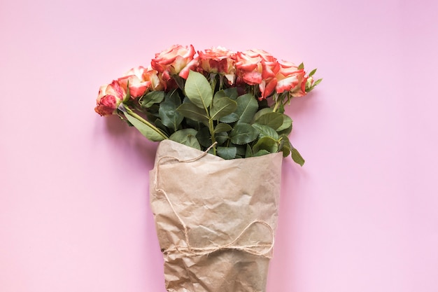 Free Photo  Pink roses bouquet wrapped in brown paper and