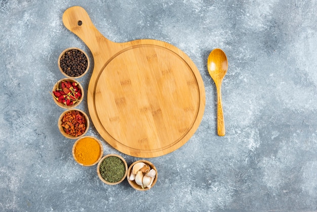 Bunch of spices with wooden board on marble background.