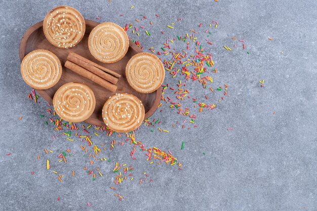 Bunch of sweet crackers on wooden plate