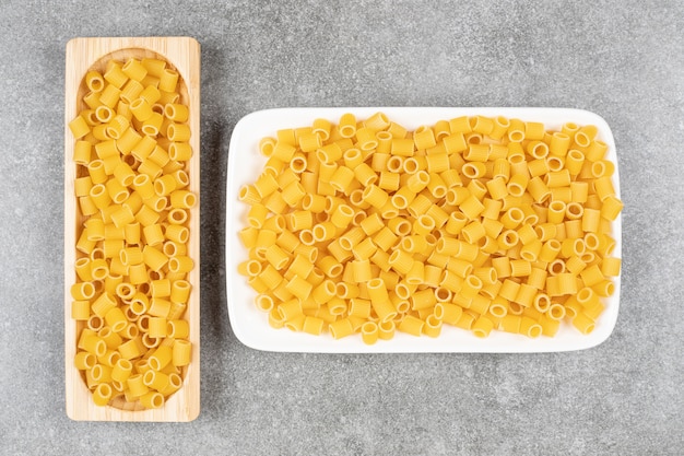 Free photo bunch of uncooked pasta on marble surface