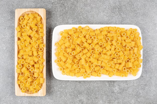 Bunch of uncooked pasta on marble surface